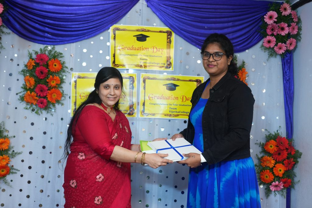 two women holding a white box